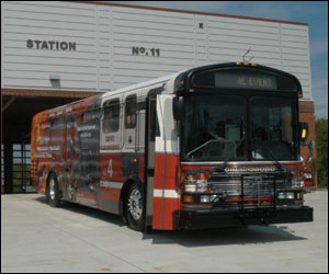 The newly wrapped city bus in front of the new Greensboro Fire Department Station 11.
