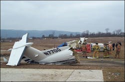 Firefighters from the Bellefonte Fire Department stand by with a handline as officials from the Centre County Coroner’s Office and FAA representatives examine the wreckage. Firefighters from the Bellefonte Fire Department stand by with a handline as officials from the Centre County Coroner’s Office and FAA representatives examine the wreckage.