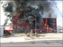 Quint 5 is positioned at the east (B) side of the structure. The elevated aerial stream and hand lines from this vehicle were alternately played upon the exposure and the fire building. Quint 5 is positioned at the east (B) side of the structure. The elevated aerial stream and hand lines from this vehicle were alternately played upon the exposure and the fire building.