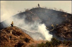 U.S. Forest Service firefighters mop up the top of a hill after a fire burned above the Chapman Heights area of Yucaipa, Calif., Thursday, July 14, 2005. Dry grass fueled a fire that rapidly burned across more than 150 acres Thursday in this San Bernardino County hillside community, but no homes or structures were lost, officials said. U.S. Forest Service firefighters mop up the top of a hill after a fire burned above the Chapman Heights area of Yucaipa, Calif., Thursday, July 14, 2005. Dry grass fueled a fire that rapidly burned across more than 150 acres Thursday in this San Bernardino County hillside community, but no homes or structures were lost, officials said.