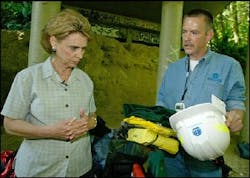 Washington Governor Christine Gregoire receives firefighting gear from Department of Natural Resource Protection Training Manager Joel Rogauskas after she completed a mile walk in 14.53 and deployed a fire shelter on Thursday, July 14, 2005 in Chehalis, WA. She is the first Washington State Governor to receive this type of instruction and to complete the work capacity test to meet safety qualifications to visit firelines this summer. Washington Governor Christine Gregoire receives firefighting gear from Department of Natural Resource Protection Training Manager Joel Rogauskas after she completed a mile walk in 14.53 and deployed a fire shelter on Thursday, July 14, 2005 in Chehalis, WA. She is the first Washington State Governor to receive this type of instruction and to complete the work capacity test to meet safety qualifications to visit firelines this summer.