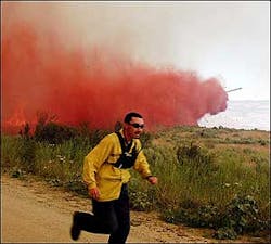 Wildland firefighter Jeff Nanampkin of the Washington Dept. of Natural Resources runs from the path of a slurry drop Wednesday, July 13, 2005, about one mile from Omak Lake in Omak, Wash. The wildfire had burned 8,000 acres on the Colville Indian reservation. Wildland firefighter Jeff Nanampkin of the Washington Dept. of Natural Resources runs from the path of a slurry drop Wednesday, July 13, 2005, about one mile from Omak Lake in Omak, Wash. The wildfire had burned 8,000 acres on the Colville Indian reservation.