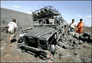 People from the nearby village look at a burned-out fire-fighting vehicles near Ribas de Saelices in the provence of Guadalajara in Spain Monday July 18, 2005.