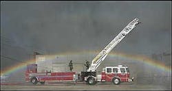 A rainbow forms in the spray from a nearby aerial snorkle truck Wednesday, July 20, 2005, over a Kansas City Fire Department truck at the scene of a four-alarm fire at ABC Tire in the West Bottoms of Kansas City, Mo. A rainbow forms in the spray from a nearby aerial snorkle truck Wednesday, July 20, 2005, over a Kansas City Fire Department truck at the scene of a four-alarm fire at ABC Tire in the West Bottoms of Kansas City, Mo.
