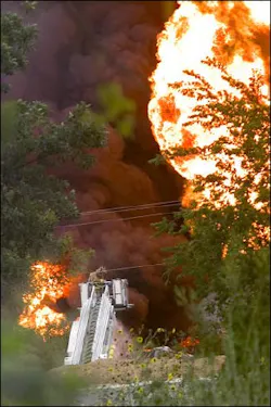 A firefighter on a ladder truck bucket battles five-alarm fire at Valley Solvents Chemicals on the north side of Fort Worth, Texas, Thursday, July 28, 2005. A firefighter on a ladder truck bucket battles five-alarm fire at Valley Solvents Chemicals on the north side of Fort Worth, Texas, Thursday, July 28, 2005.