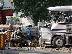 An Avon fire department captain, left, stands near the remains of a fiery multiple vehicle crash that killed several people, Friday, July 29, 2005, in Avon, Conn. An Avon fire department captain, left, stands near the remains of a fiery multiple vehicle crash that killed several people, Friday, July 29, 2005, in Avon, Conn.