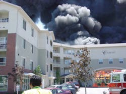 The most significant exposure was this large, multi-unit apartment building and the parking structure to its rear. Firefighting crews and aerial master streams were utilized to successfully prevent the spread of fire into this heavily inhabited structure.