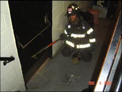 A firefighter uses the six-foot hook to probe along the wall to find and identify windows and doors. The tool also will let the searching member maintain contact with the wall and search a few feet off the wall. By using the tool this way, the firefighter can place a hole in the ceiling above to make sure no fire is overhead.
