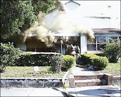 The crew of Engine 5 stretches a 2.5-inch backup line as Engine 3 begins an interior attack in the boarded-up structure. The crew of Engine 5 stretches a 2.5-inch backup line as Engine 3 begins an interior attack in the boarded-up structure.