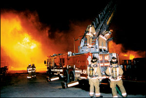 Firefighters set up several ladder pipes. Members of one ladder company were forced to break down and retreat as the fire threatened to overtake their position.