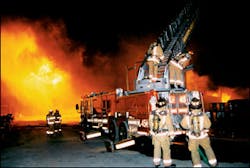 Firefighters set up several ladder pipes. Members of one ladder company were forced to break down and retreat as the fire threatened to overtake their position. Firefighters set up several ladder pipes. Members of one ladder company were forced to break down and retreat as the fire threatened to overtake their position.