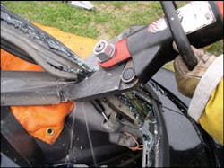 This field test involved intentionally cutting into and through a hatchback strut. At this point, there is obvious damage being inflicted to the strut; however, there is no failure of the strut itself.