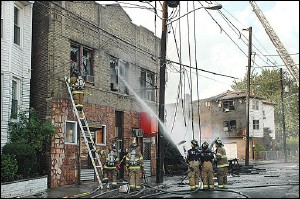 Jersey City firefighters work to contain a fire Wednesday, Aug. 3, 2005, in Jersey City, N.J.