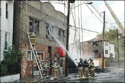 Jersey City firefighters work to contain a fire Wednesday, Aug. 3, 2005, in Jersey City, N.J.