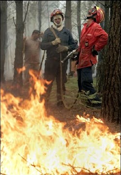 Exhausted Firefighters and volunteers fight a fire Friday, Aug. 5, 2005, near Leiria some 150 kilometers (90 miles) north of Lisbon. Some 2,900 firefighters, supported by about 900 vehicles, were on duty Friday fighting forest fires in northern and central Portugal. Exhausted Firefighters and volunteers fight a fire Friday, Aug. 5, 2005, near Leiria some 150 kilometers (90 miles) north of Lisbon. Some 2,900 firefighters, supported by about 900 vehicles, were on duty Friday fighting forest fires in northern and central Portugal.