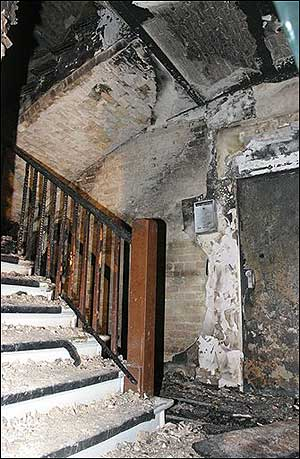 The burned out stairway of a house in Berlin is seen early Tuesday, Aug. 9, 2005. Fire broke out in the stairway of a five-story Berlin apartment building, killing eight people, including four children, in what police said Tuesday may have been arson.