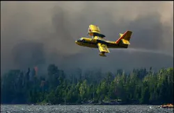 A tanker lifts off Sea Gull Lake in the Boundary Waters Canoe Area Wilderness, Monday afternoon, Aug 8, 2005, after picking up a tank of water from the lake to fight the Forest fire between Alpine and Sea Gull Lake, Minn. Drizzle helped firefighters Tuesday as they worked to contain the wildfire that has grown to about 690 acres. A tanker lifts off Sea Gull Lake in the Boundary Waters Canoe Area Wilderness, Monday afternoon, Aug 8, 2005, after picking up a tank of water from the lake to fight the Forest fire between Alpine and Sea Gull Lake, Minn. Drizzle helped firefighters Tuesday as they worked to contain the wildfire that has grown to about 690 acres.