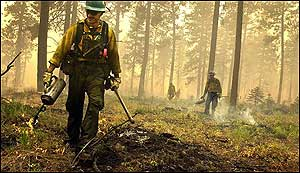 Flagstaff, Ariz., firefighter Derek Schloss, works a wildfire Wednesday, Aug. 10, 2005, near Pomeroy Wash. About 1,600 firefighters and support personnel were assigned to the School fire, which stood at 41,000 acres and was 45 percent contained Wednesday.
