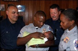 Fire Technician Hector Areizaga, Police Corporal Banks, Fire Captain Gigliotti and Police Officer Clarke with Baby Craig. Fire Technician Hector Areizaga, Police Corporal Banks, Fire Captain Gigliotti and Police Officer Clarke with Baby Craig.