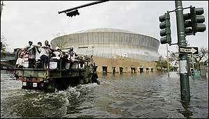 National Guard trucks haul residents through floodwaters to the Superdome after Hurricane Katrina hit in New Orleans, Tuesday, Aug. 30, 2005. Officials called for a mandatory evacuation of the city, but many residents remained in the city.