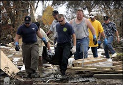 Members of the Mississippi Fire Department, funeral employees and volunteers carry the body of a man who was killed when his home collapsed during Hurricane Katrina in Biloxi, Miss., Thursday, Sept. 1, 2005. The man was found in the rubble of his home. Members of the Mississippi Fire Department, funeral employees and volunteers carry the body of a man who was killed when his home collapsed during Hurricane Katrina in Biloxi, Miss., Thursday, Sept. 1, 2005. The man was found in the rubble of his home.