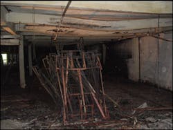 Tables completely consumed by fire heated and deformed massive I-beam. Tables completely consumed by fire heated and deformed massive I-beam.