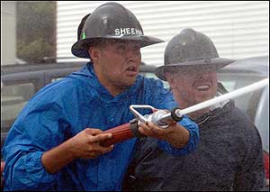 Ebensburg, Pa., volunteer fireman Mike Sheehan, left, and Fire Chief Dale Makin participate in an activity.