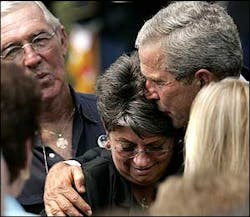 President Bush comforts a family member of New York City Firefighter Kevin M. Prior who died on 9/11 during a ceremony on the South Lawn of the White House, Friday, Sept. 9, 2005. Bush hosted the event for the 9/11 Heroes Medal of Valor Award Ceremony. Nearly four years after the terrorist attacks on the World Trade Center and the Pentagon, Bush praised the heroes of Sept. 11, 2001 and reasserted his commitment to the war on terror.