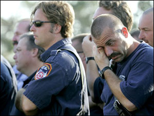 A firefighter wipes away tears during a Catholic mass celebrated in memory of the 343 New York City firefighters killed at the World Trade Center four years ago, Sunday, Sept. 11, 2005, in New Orleans. The mass was held for firefighters from all over the country currently stationed in New Orleans.