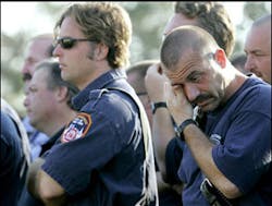 A firefighter wipes away tears during a Catholic mass celebrated in memory of the 343 New York City firefighters killed at the World Trade Center four years ago, Sunday, Sept. 11, 2005, in New Orleans. The mass was held for firefighters from all over the country currently stationed in New Orleans. A firefighter wipes away tears during a Catholic mass celebrated in memory of the 343 New York City firefighters killed at the World Trade Center four years ago, Sunday, Sept. 11, 2005, in New Orleans. The mass was held for firefighters from all over the country currently stationed in New Orleans.