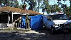Firefighters use a tarp to block the view of a body being removed from a home in Gary, Ind., Wednesday Sept. 21, 2005. Bars on the windows may have kept victims from escaping a house fire that killed three children and two adults early today in Gary, Indiana. A fire department inspector says nine people were inside the house, and two are hospitalized in serious condition. The cause has not been determined. Firefighters use a tarp to block the view of a body being removed from a home in Gary, Ind., Wednesday Sept. 21, 2005. Bars on the windows may have kept victims from escaping a house fire that killed three children and two adults early today in Gary, Indiana. A fire department inspector says nine people were inside the house, and two are hospitalized in serious condition. The cause has not been determined.