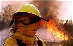 Riverside County firefighter Corey Clauson turns his face from the flames while battling a fire at Heart Land Stables on San Timoteo Canyon Road near Redlands, Calif. Riverside County firefighter Corey Clauson turns his face from the flames while battling a fire at Heart Land Stables on San Timoteo Canyon Road near Redlands, Calif.