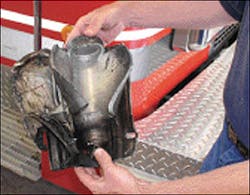 Author holds the two components of the frontal airbag unit that exploded in the McKinney, TX, incident. Note that the stored-gas inflator cylinder has ruptured in a fashion similar to a BLEVE. The inflator and the backing plate landed just over 120 feet away from the burning vehicle after the explosion. Author holds the two components of the frontal airbag unit that exploded in the McKinney, TX, incident. Note that the stored-gas inflator cylinder has ruptured in a fashion similar to a BLEVE. The inflator and the backing plate landed just over 120 feet away from the burning vehicle after the explosion.