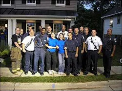 Extreme Makover Firefighters and Paramedics pose with two of the shows producers in front of the new home. Extreme Makover Firefighters and Paramedics pose with two of the shows producers in front of the new home.