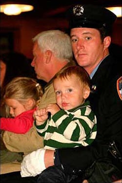 EXTENDED FAMILY: Firefighter Brendan Cawley yesterday with the family of John Bellew, who died in the line of duty. EXTENDED FAMILY: Firefighter Brendan Cawley yesterday with the family of John Bellew, who died in the line of duty.