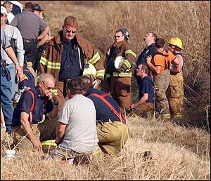 Greg Hickman, Neosho fire chief, and Andy Nimmo (standing), Redings Mills fire chief, huddle around each other hours after losing a fireman to death while fighting a fire at Ragland Mills, located just outside the Neosho city limits on 14079 Hammer Road. As of 5 p.m., the name of the fireman has not been released.