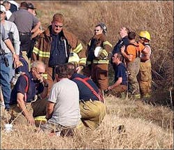Greg Hickman, Neosho fire chief, and Andy Nimmo (standing), Redings Mills fire chief, huddle around each other hours after losing a fireman to death while fighting a fire at Ragland Mills, located just outside the Neosho city limits on 14079 Hammer Road. As of 5 p.m., the name of the fireman has not been released. Greg Hickman, Neosho fire chief, and Andy Nimmo (standing), Redings Mills fire chief, huddle around each other hours after losing a fireman to death while fighting a fire at Ragland Mills, located just outside the Neosho city limits on 14079 Hammer Road. As of 5 p.m., the name of the fireman has not been released.