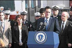 Gov. Mitt Romney speaks at the Lancaster fire station before signing the McNamara Law, Tuesday morning. Claire McNamara, wife of the late call firefighter for whom the law is named, stands at left.