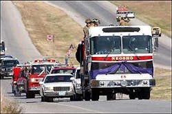 A Neosho fire engine bears the casket of Tim Hardy on Missouri Highway 59 to Oakwood Cemetery.