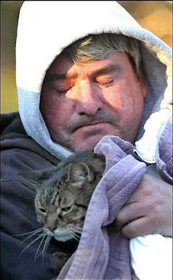 Hugh Griffith, a resident in one of the damaged condos, hugs his cat, Calvin, who was rescued by firefighters. Hugh Griffith, a resident in one of the damaged condos, hugs his cat, Calvin, who was rescued by firefighters.