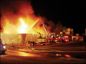 After worsening conditions forced interior crews to withdraw, defensive operations were initiated using two aerials, a deck gun and handlines.