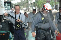 FL-TF1 Hazmat Specialist Hal Martin, left, uses a pressure water cleaner to decontaminate FL-TF1 member John Smithies after a day of searching homes in the Ninth Ward. Pressure cleaners were necessary to remove the thick mud that covered task force members from head to toe. FL-TF1 Hazmat Specialist Hal Martin, left, uses a pressure water cleaner to decontaminate FL-TF1 member John Smithies after a day of searching homes in the Ninth Ward. Pressure cleaners were necessary to remove the thick mud that covered task force members from head to toe.