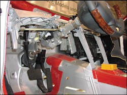 The S-Class Mercedes-Benz steering column’s swivel linkage is shown just above floorboard level. It is evident that any pulling effort applied to the upper section of this split column will raise only this portion of the column. Note the telescoping feature of the steering column is also visible near the base of the steering wheel. The S-Class Mercedes-Benz steering column’s swivel linkage is shown just above floorboard level. It is evident that any pulling effort applied to the upper section of this split column will raise only this portion of the column. Note the telescoping feature of the steering column is also visible near the base of the steering wheel.