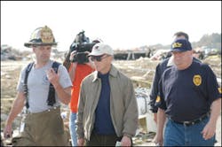 Knight Township Assistant Fire Chief Dale Naylor, left, the incident commander, reviews emergency operations with Indiana Governor Mitchell E. Daniels Jr. and State Fire Marshal Roger D. Johnson.