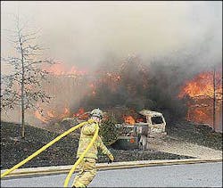 A firefighter moves a hose down the street while trying to stay ahead of a fast-moving fire that destroyed four homes in the Bethelview Downs subdivision in Cumming. A firefighter moves a hose down the street while trying to stay ahead of a fast-moving fire that destroyed four homes in the Bethelview Downs subdivision in Cumming.