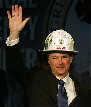 FEMA Director David Paulison waves to his emergency services colleagues after being presented with a white helmet.
