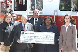 Officials from the National Fallen Firefighters Foundation accept a $1 million check from Motorola.