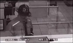 This bank surveillance photo shows the robbery suspect disguised as a firefighter. This bank surveillance photo shows the robbery suspect disguised as a firefighter.