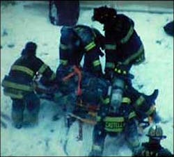 Video footage shows firefighters aiding a comrade (above) on Jan. 23, 2005, after he and five others leaped from a burning building.