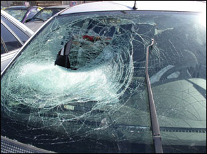 Be real careful here. It is not normal, although possible, that a deploying passenger frontal airbag will tear a hole in the laminated glass. Look at the glass for hair or flesh on the inside and the outside. This damage could be caused by a person or object into which this vehicle ran.